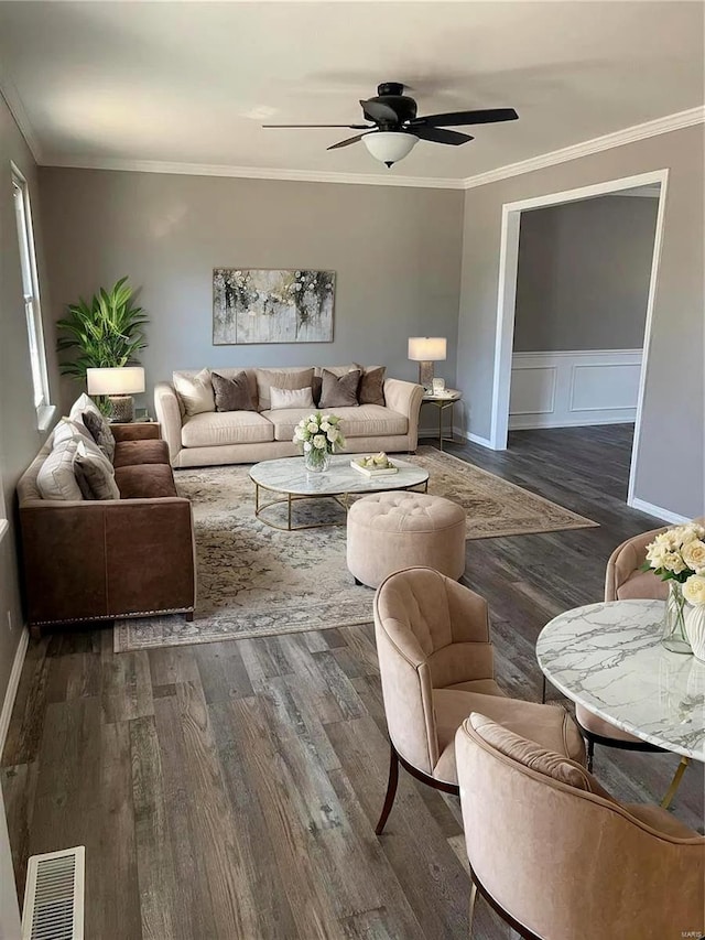 living room featuring ornamental molding, ceiling fan, and dark hardwood / wood-style floors