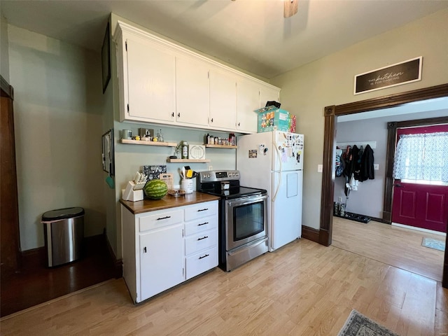 kitchen featuring ceiling fan, stainless steel electric range oven, white fridge, white cabinets, and light wood-type flooring