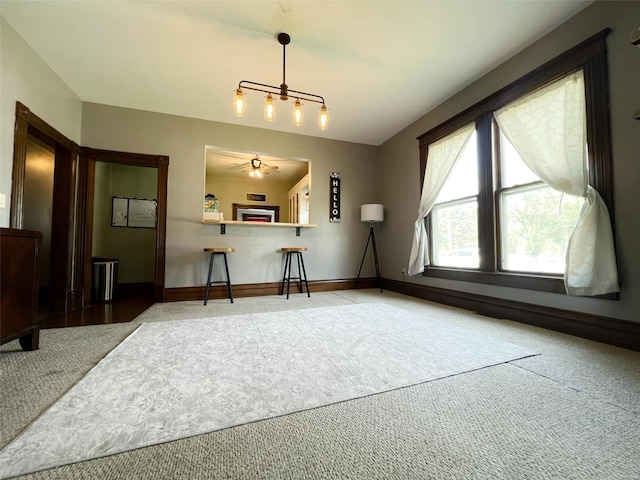 interior space featuring carpet and ceiling fan