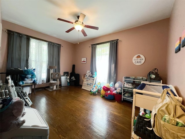 interior space featuring ceiling fan and dark wood-type flooring