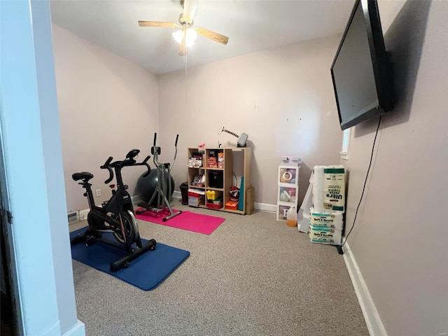 workout room featuring carpet and ceiling fan