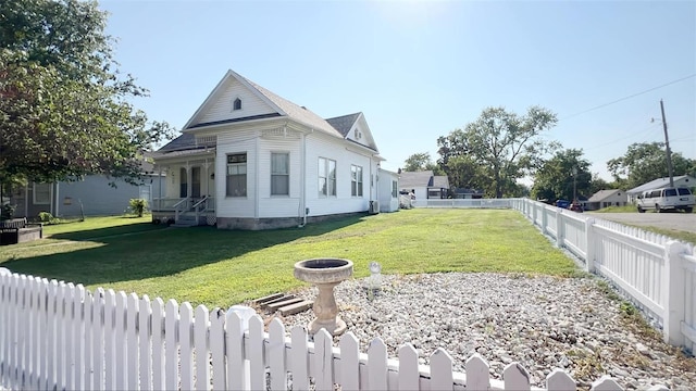 view of side of property with a lawn