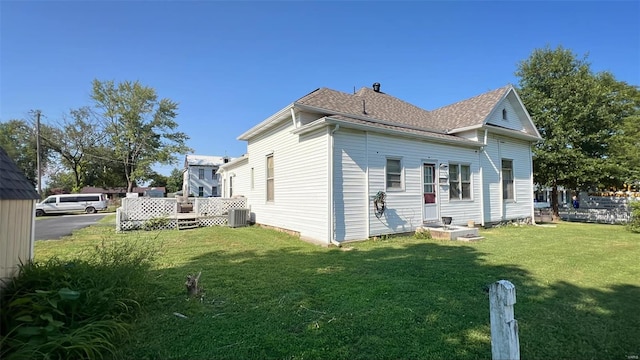 view of home's exterior featuring a lawn and central AC unit