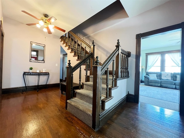 staircase with hardwood / wood-style flooring and ceiling fan