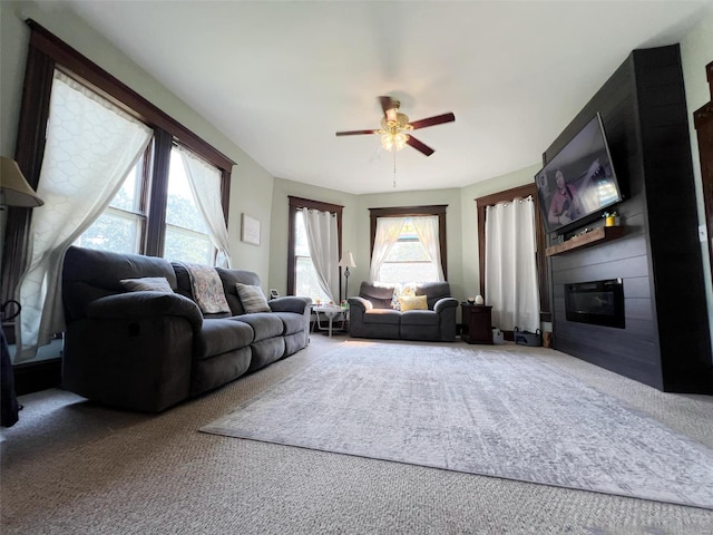 carpeted living room with ceiling fan