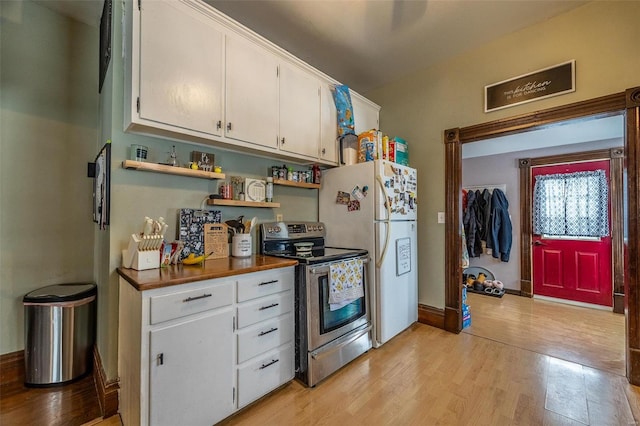 kitchen featuring white cabinetry, white refrigerator, stainless steel electric stove, and light hardwood / wood-style floors