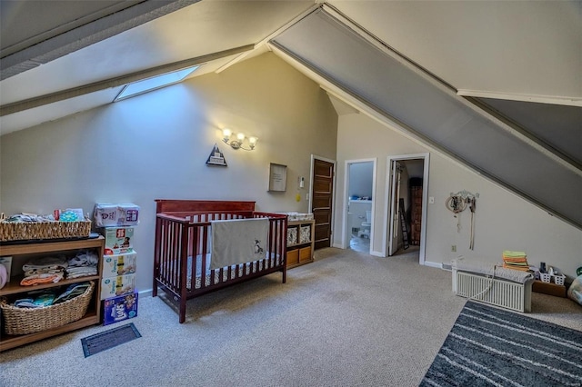 carpeted bedroom with vaulted ceiling with skylight