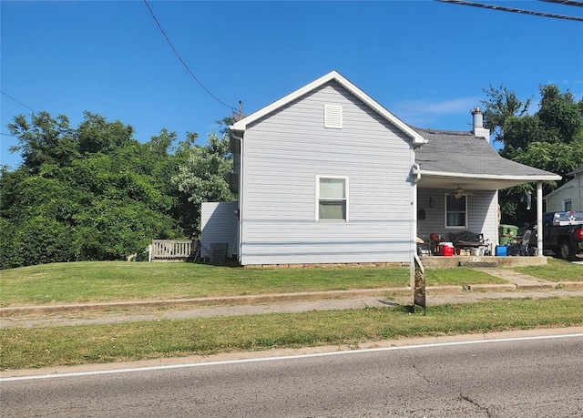 view of property exterior with a lawn and covered porch