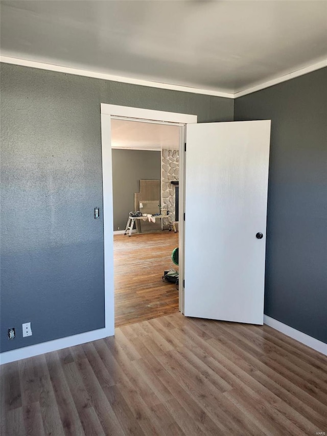 unfurnished room with baseboards and wood finished floors