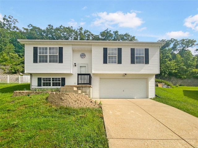 raised ranch with a front yard and a garage