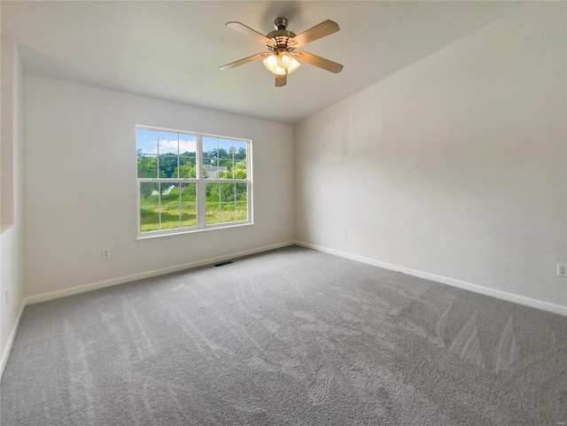 spare room featuring ceiling fan and carpet floors