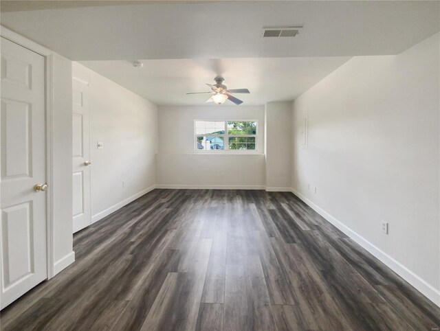 empty room with ceiling fan and dark hardwood / wood-style floors