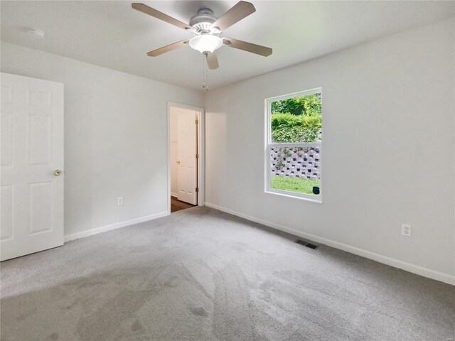 empty room with ceiling fan and carpet