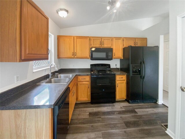 kitchen featuring black appliances, sink, dark hardwood / wood-style floors, and lofted ceiling