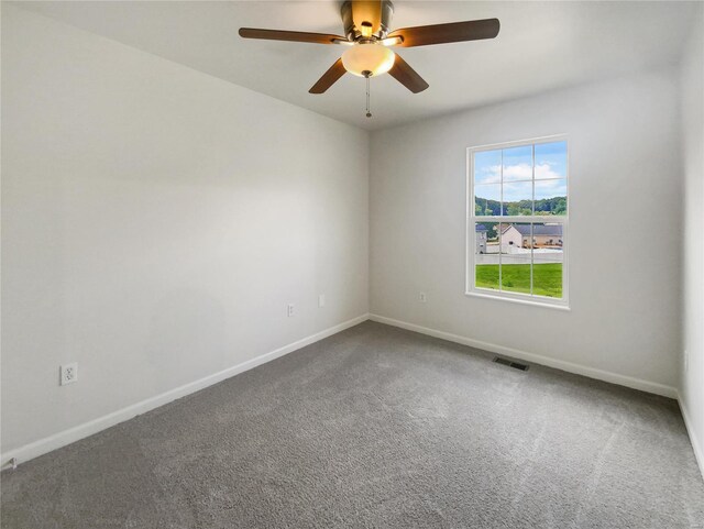 unfurnished room with ceiling fan and carpet floors