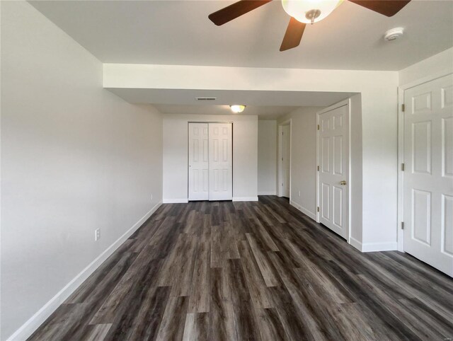 empty room featuring ceiling fan and dark hardwood / wood-style flooring