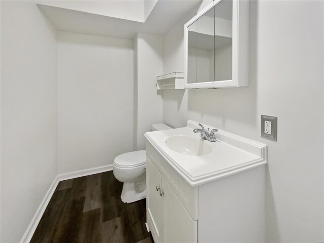 bathroom featuring hardwood / wood-style flooring, vanity, and toilet