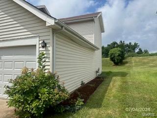 view of side of home with a yard