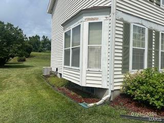 view of side of home featuring a yard