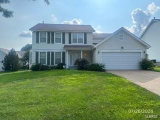 view of front of house featuring a front lawn and a garage