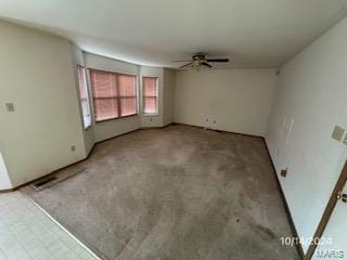 empty room featuring ceiling fan and carpet floors