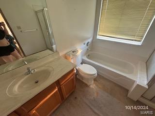 full bathroom with vanity, toilet, and separate shower and tub