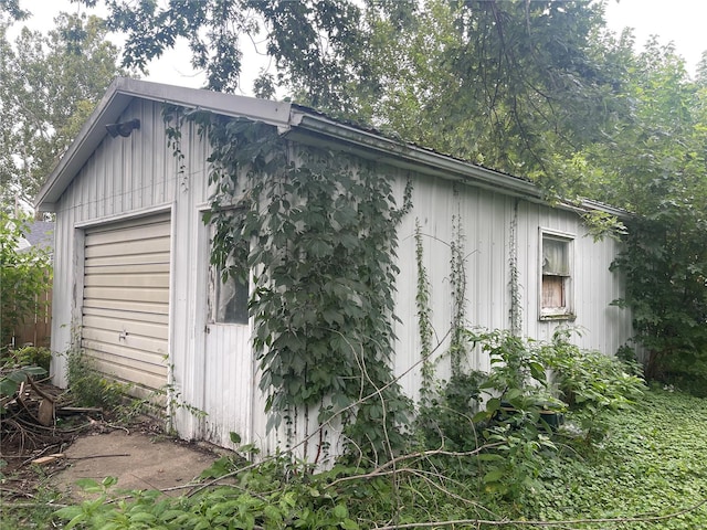 exterior space featuring a garage and an outdoor structure