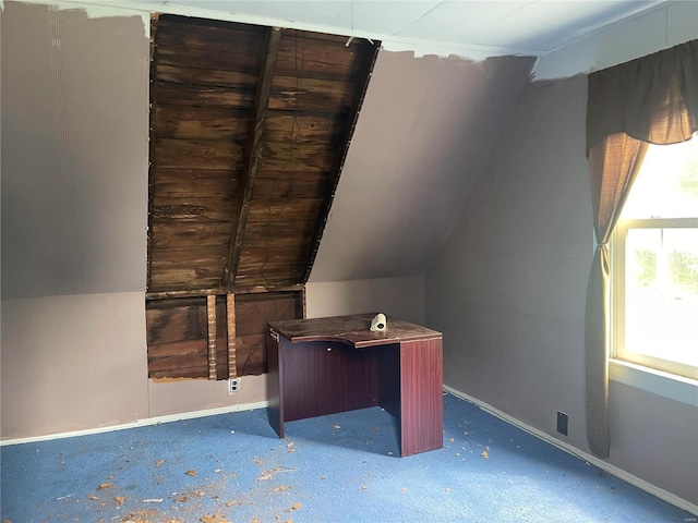 additional living space featuring vaulted ceiling and carpet flooring