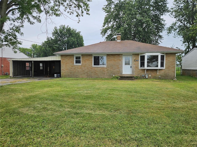 ranch-style home with brick siding, a chimney, and a front lawn