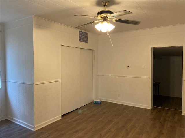 unfurnished bedroom with dark hardwood / wood-style floors and ceiling fan