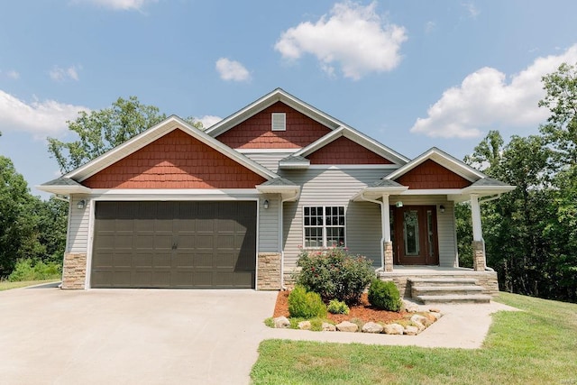 craftsman house with stone siding, an attached garage, and concrete driveway