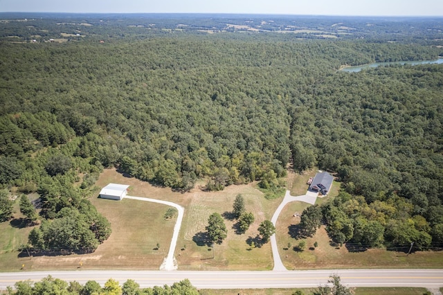 birds eye view of property featuring a water view and a forest view