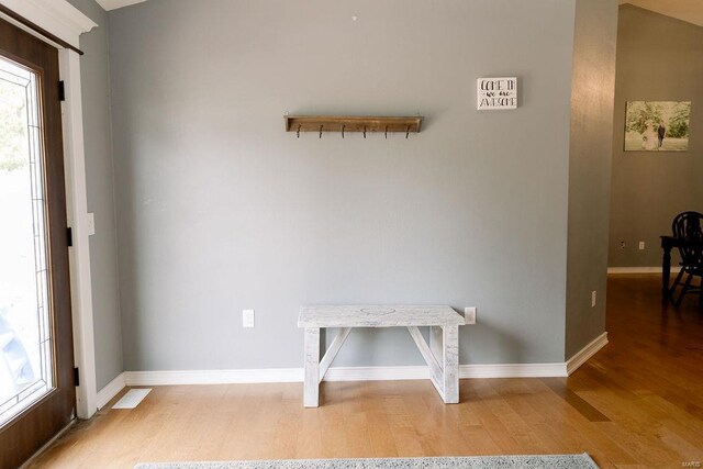 interior space with light hardwood / wood-style floors and vaulted ceiling