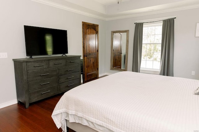 bedroom featuring baseboards, dark wood-style flooring, and crown molding