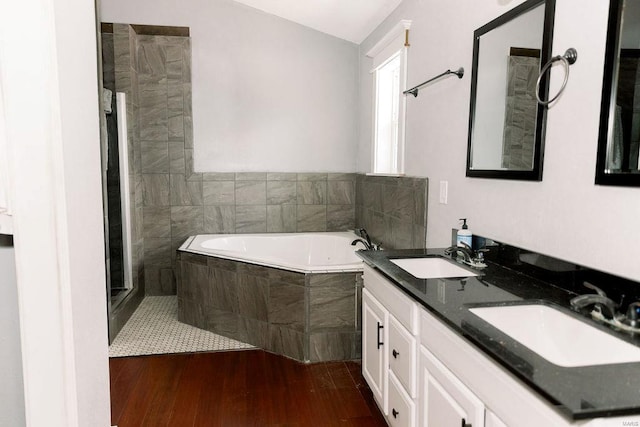 full bathroom featuring a sink, a tile shower, a bath, and wood finished floors