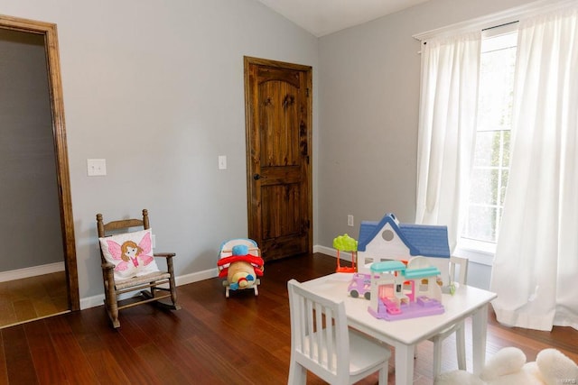 game room with vaulted ceiling, wood finished floors, and baseboards