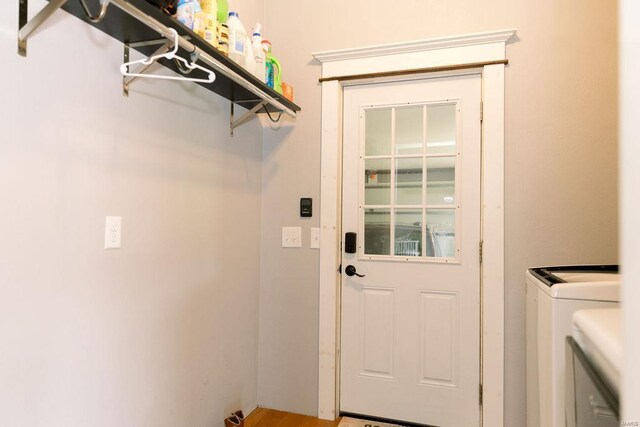 laundry room featuring washer and dryer and wood-type flooring