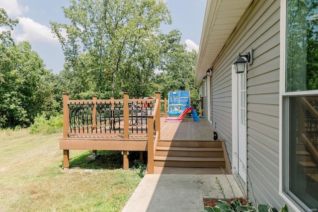 wooden terrace featuring a yard