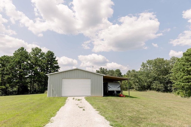 garage with driveway and a detached garage