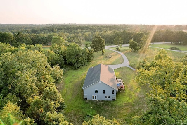 birds eye view of property featuring a view of trees