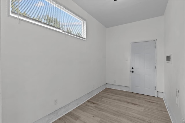 unfurnished room with light wood-type flooring