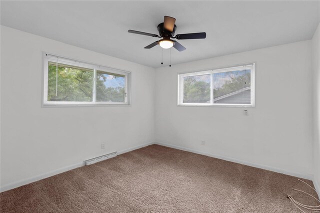 spare room featuring carpet, ceiling fan, and a healthy amount of sunlight