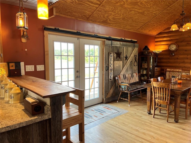 doorway to outside with rustic walls, light wood-type flooring, lofted ceiling, and wooden ceiling