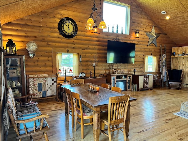 dining space featuring rustic walls, high vaulted ceiling, wood-type flooring, and wood ceiling