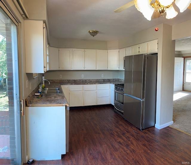 kitchen featuring appliances with stainless steel finishes, sink, white cabinetry, ceiling fan, and dark hardwood / wood-style floors