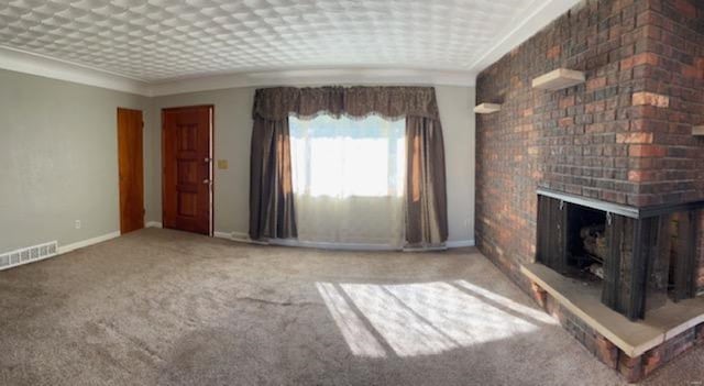 unfurnished living room with carpet and a fireplace