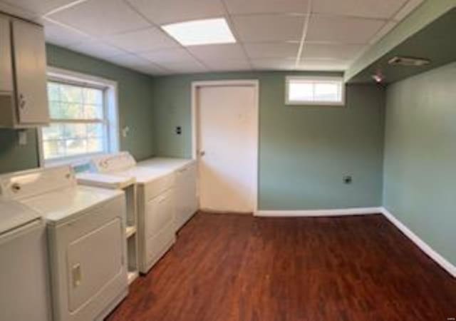 laundry area featuring washer and dryer and dark hardwood / wood-style flooring