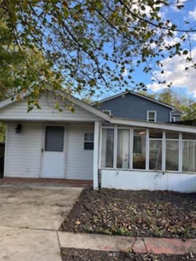 back of property featuring a sunroom