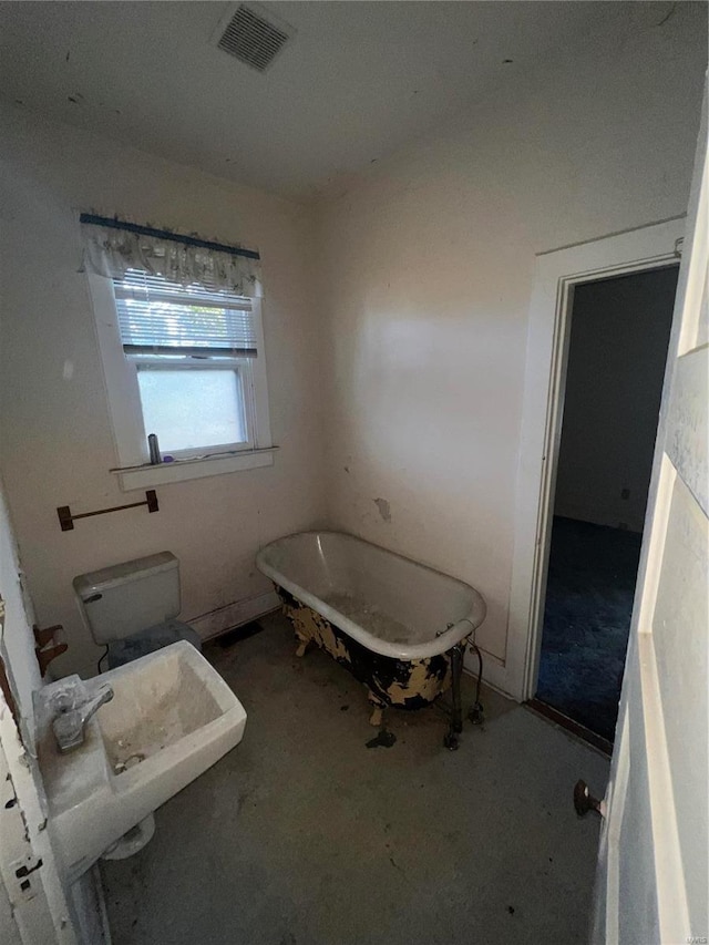 bathroom with toilet and a bath