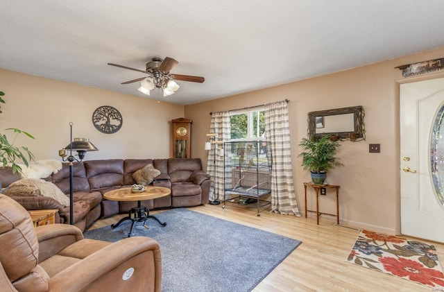 living room with ceiling fan and light hardwood / wood-style floors